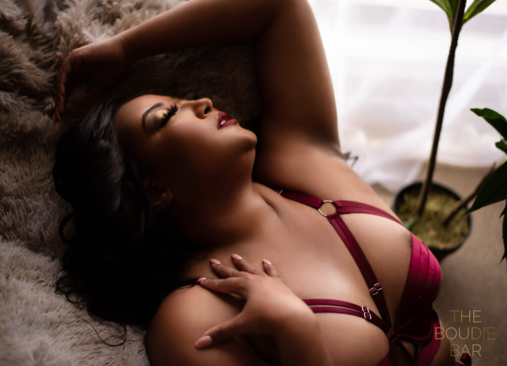 boudoir image of a half black, half Asian woman in red lingerie.