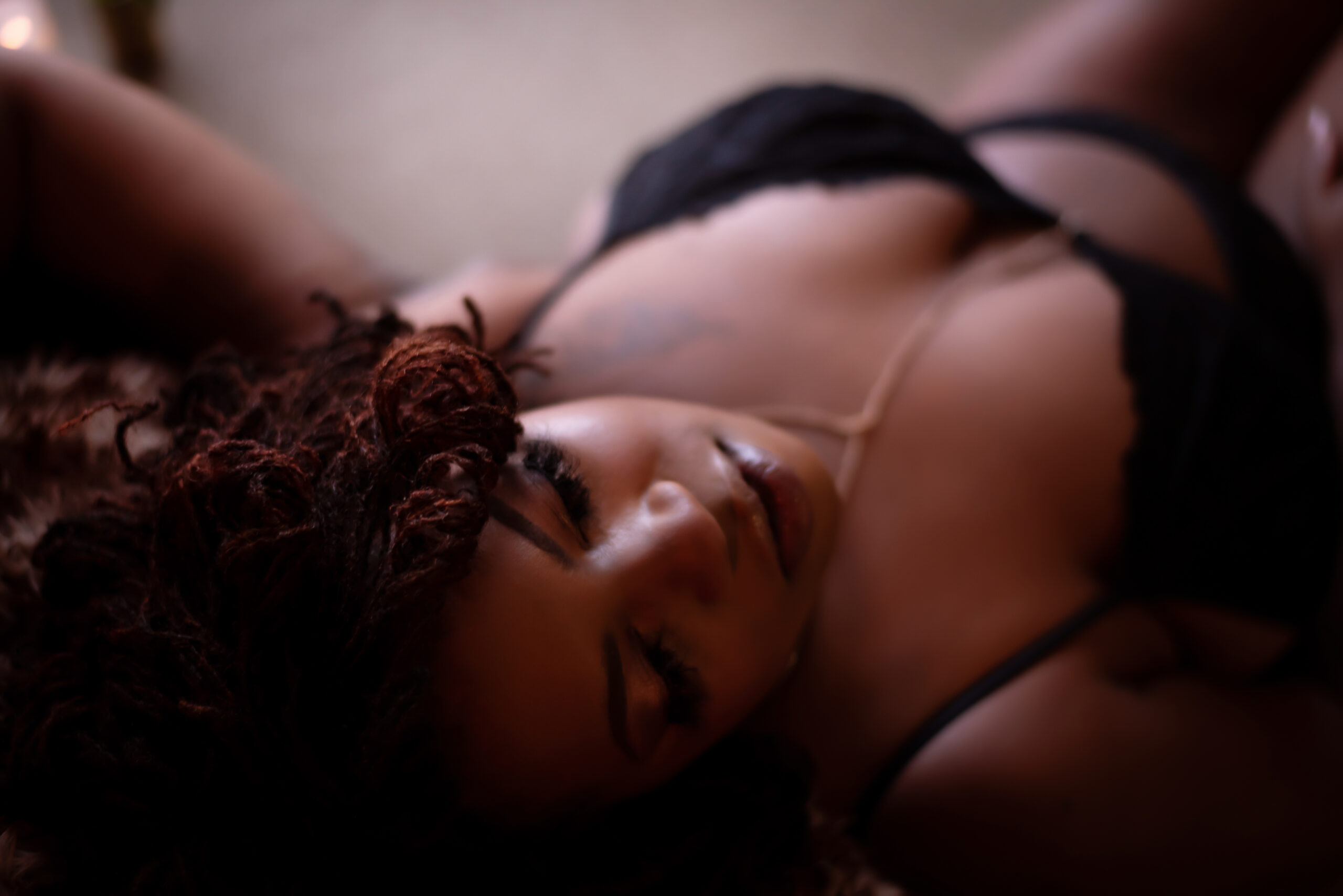 An Atlanta boudoir photo with a black woman in black lingerie.