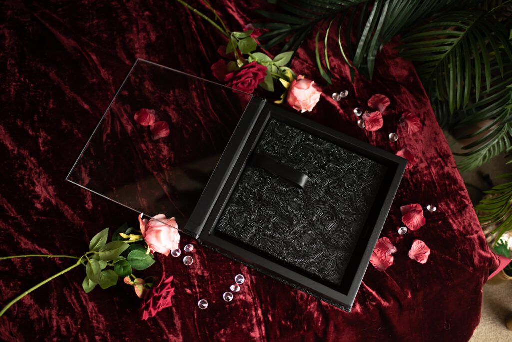 A black boudoir album with an intricate design on it.
