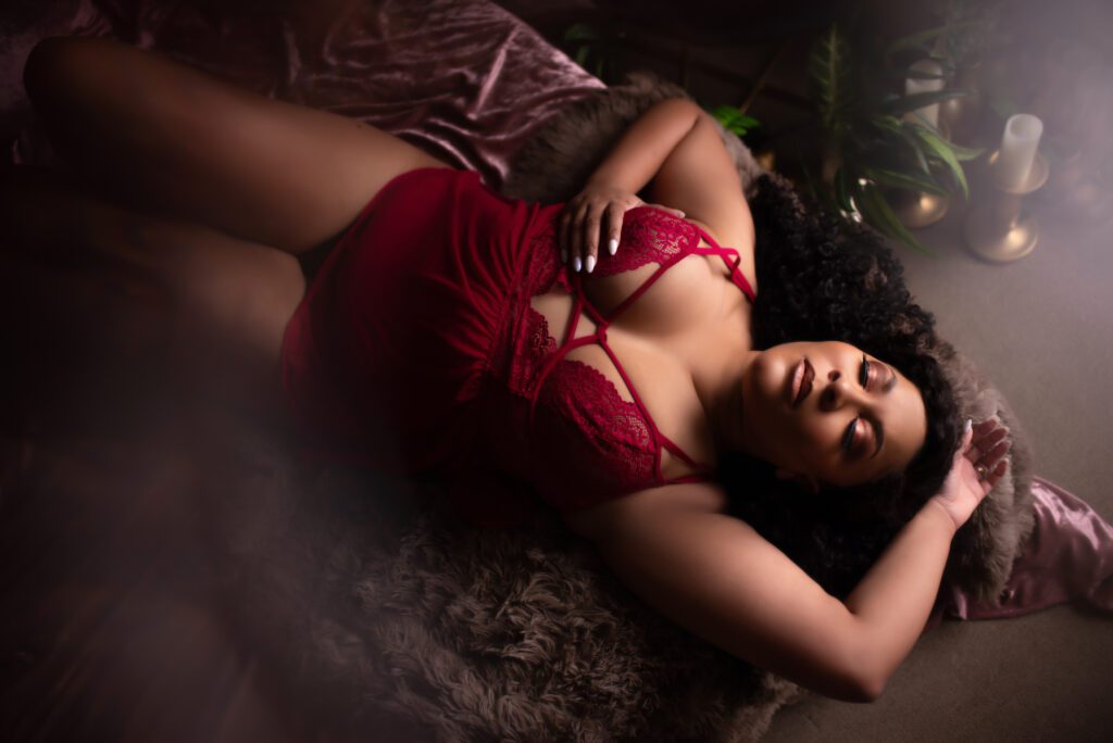 Atlanta boudoir photo featuring a black woman in a red bodysuit.